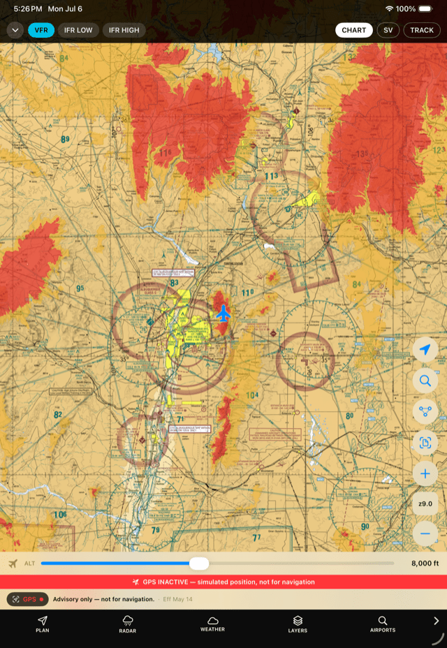 Aircraft-relative terrain shading with red and amber elevation bands over mountainous terrain on the chart